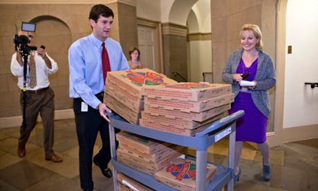 An aide brings a cart stacked with pizza to the office of Speaker of the House John Boehner, R-Ohio, as movement toward ending the government shutdown was suddenly halted, at the Capitol in Washington, Tuesday night, Oct. 15, 2013. Time growing desperately short, House Republicans pushed for passage of legislation late Tuesday to prevent a threatened Treasury default, end a 15-day partial government shutdown and extricate divided government from its latest brush with a full political meltdown. (AP Photo/J. Scott Applewhite)